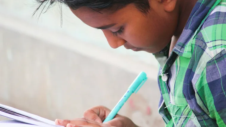A student writing in a notebook